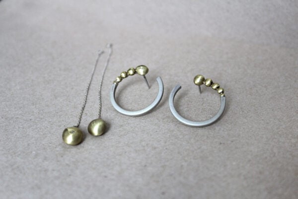 Elegant and modern on their own, or complimentary with delicate chain , these earrings are a one of a kind creation and are comprised of 925k sterling silver and brass. The delicate chain are further enhanced with brass drops and a little zircon on it. The circle has Sandblasted finished and it looks frozen in contrast with rustic brass . You can wear this earrings with and without chain matching with dresses and occasions. Please note: Due to our jewelry being handmade, each piece is unique and may not be identical to the picture shown above. The EARRINGS has been made by hand. We can make It to order in your specific size, model... do get in touch for any advice if you are unsure. Each item is packaged individually in a GIFT BOX To keep clean we recommend using only a specialized silver and gold polishing cloth. Never wear silver or gold jewelry when swimming or bathing. If you have any special requests or have any questions, please feel free to contact me. Most things can be accommodated. Check out our other products: