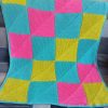 Bright pied hand knitted baby blanket