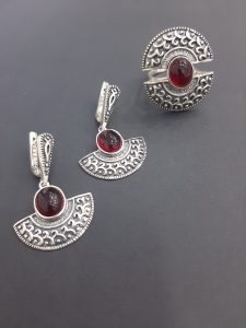 silver jewelry with red stone