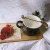 Decorative coffee mug with saucer and spoon